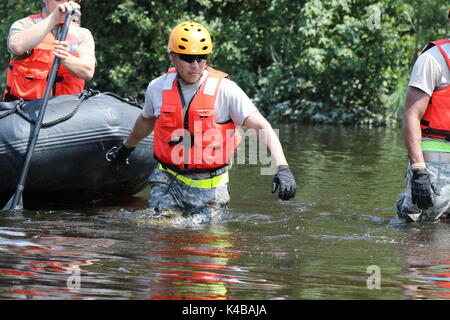 U.S Army soldiers use a rubber boat to search for residents in need of assistance trapped by floodwaters in the aftermath of Hurricane Harvey September 4, 2017 in Port Arthur, Texas. Stock Photo