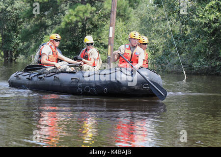 U.S Army soldiers use a rubber boat to search for residents in need of assistance trapped by floodwaters in the aftermath of Hurricane Harvey September 4, 2017 in Port Arthur, Texas. Stock Photo