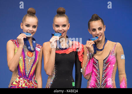 Pesaro, Italy. 1st Sep, 2017. (L-R) Arina Averina, Dina Averina (RUS), Linoy Ashram (ISR) Rhythmic Gymnastics : Gold medalist Dina Averina of Russia, silver medalist Arina Averina of Russia and bronze medalist Linoy Ashram of Israel react with their medals on the podium during the medal ceremony for the 35th Rhythmic Gymnastics World Championships 2017 Individual All-Around at Adriatic Arena in Pesaro, Italy . Credit: Enrico Calderoni/AFLO SPORT/Alamy Live News Stock Photo