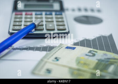 Pen, graphs, calculator, pen and euro money, finance concept, home economics. Stock Photo