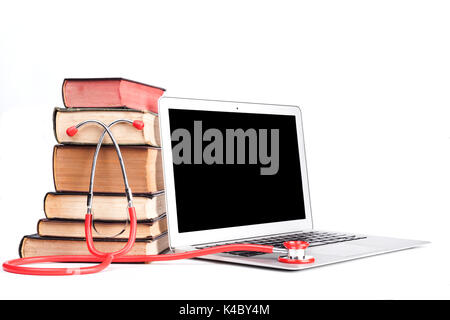 Silver laptop with red stethoscope and old pooks pile isolated on white background Stock Photo
