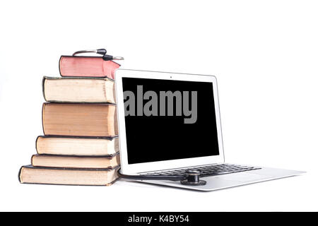 Silver laptop with black stethoscope and old pooks pile isolated on white background Stock Photo