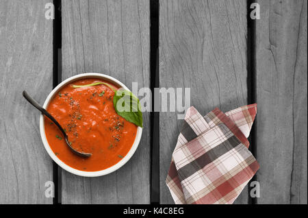 roasted tomato basil soup on wooden table Stock Photo