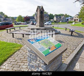 An information board next to the old village water pump at Hartington village in the Derbyshire Peak District, England, UK Stock Photo