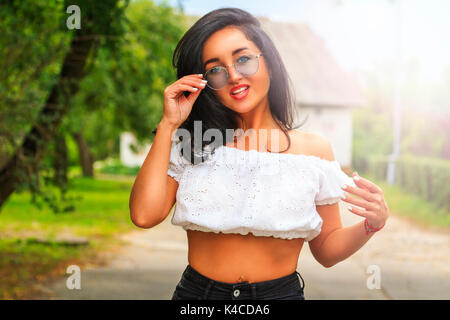 happy European girl with glasses and white blouse , fashion style, smile and a good mood Stock Photo