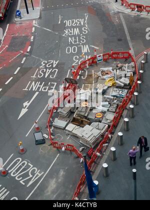 Two men shake hands beside a materials store for the roadworks on Westminster Bridge, London, UK. Stock Photo