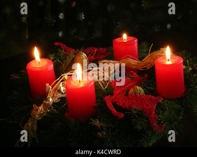 Advent Wreath With Four Burning Candles, Candlelight On The Fourth Advent Stock Photo