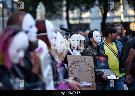 Earthlings Experience animal rights activists protesting outside Burger King in Leicester Square, London. Protesters wearing anonymous masks Stock Photo