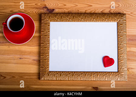 Layout with empty photo frame with cup of espresso and small red heart. Free copy space Stock Photo