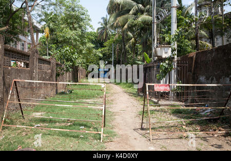Barbed wire barricades and police post outside deserted Muslim Mosque. Sittwe, Rakhine State, Myanmar Stock Photo