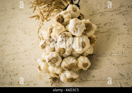 Garlic hanging on the wall Stock Photo