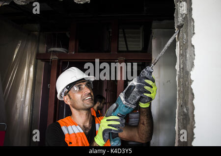 Construction worker working with hammer drill Stock Photo