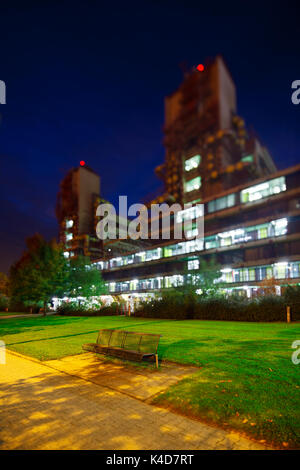 The modern university clinic of Aachen, Germany with night blue sky. Perspective corrected via lens shift, selective focus on the bench via lens tilt. Stock Photo