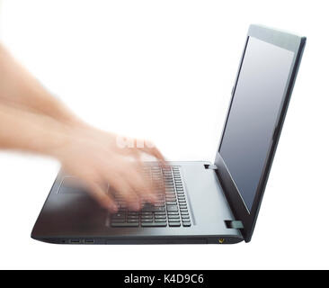 hands typing and working fast on laptop keyboard Stock Photo