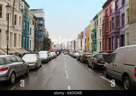 LONDON, UNITED KINGDOM - January 19; Street with colurful houses and cars under snow during winter in London, United Kingdom - January 19, 2013; Stree Stock Photo