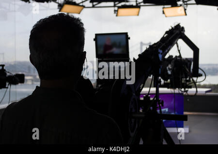 Silhouette cameraman using camera in live broadcast Stock Photo