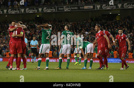 Republic of Ireland players look dejected as Serbia players celebrate at full time during the 2018 FIFA World Cup Qualifying, Group D match at the Aviva Stadium, Dublin. Stock Photo