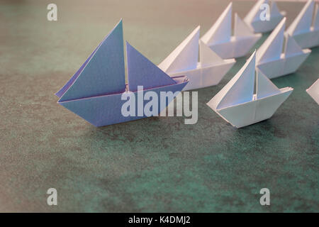 Origami paper sailboats, leadership business concept, toning Stock Photo
