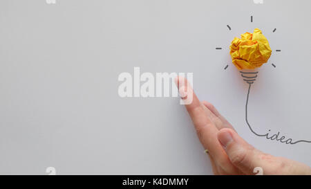 Yellow paper light bulb on hand, innovative, creative thinking business concept Stock Photo