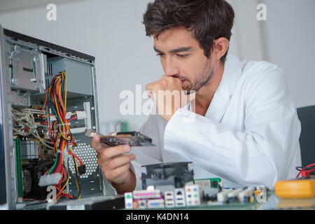 computer engineer working on broken console Stock Photo