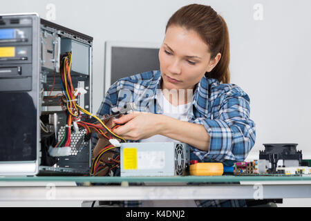technician fixing cable in server room Stock Photo