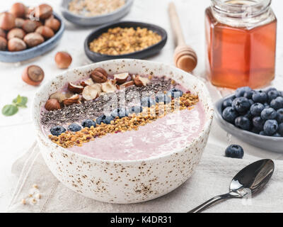 Healthy breakfast. Buckwheat Porridge. Raw buckwheat vegan breakfast smoothie bowl with fresh blueberries, nuts, chia seeds and bee pollen. Clean eati Stock Photo