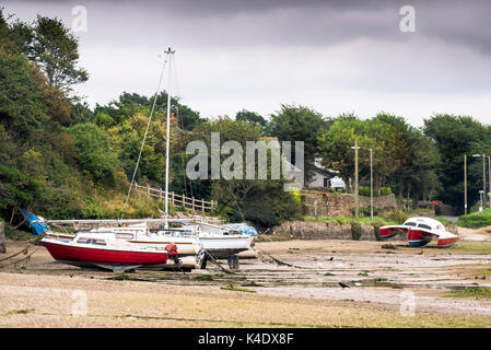 Various boats moored on the Gannel River at low tide. Stock Photo
