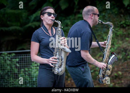 Two musicians performing on their saxophones. Stock Photo