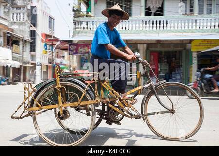Tricycle taxi or sai kaa negotiates traffic in Sittwe, Rakhine State,  Myanmar Stock Photo