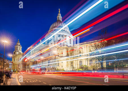 London, England - Beautiful Saint Paul's Cathedral with iconic red double decker buses on the move with light trails at night Stock Photo