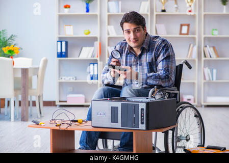 Computer repairman on wheelchair working Stock Photo