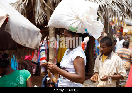 SOFIA ,MADAGASCAR NOVEMBER 4.2016 Malagasy woman transport cargo on head. Ordinary peoples life. Madagascar, November 4. 2016 Stock Photo