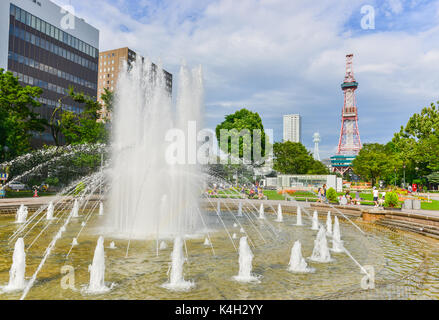 SAPPORO, HOKKAIDO, JAPAN - August 8, 2014: Unidentified people at the Fountain of Odori park in front of Sapporo TV tower. Stock Photo