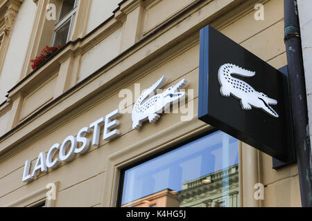Lacoste sign on a store. Lacoste is a French clothing company that sells high-end clothing, footwear, perfume, leather goods, and most famously polo s Stock Photo