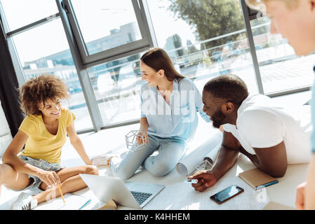 Positive international students sharing their ideas Stock Photo