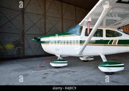 A small plane, parked in hangar airplane. Stock Photo
