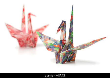 Two origami paper crane birds on white background Stock Photo