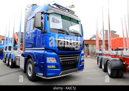 JYVASKYLA, FINLAND - MAY 18, 2017: New MAN TGX 35.640 8X4-4 BL truck and Alucar log trailer on display on Kuljetus 2017, a professional event for tran Stock Photo