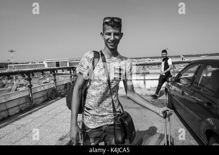 Italy, Milan, Malpensa airport, young Egyptian migrant returns to his country after five years away from the family Stock Photo