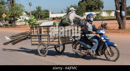 Motorcycle towing cart with cargo in Siem Reap, Cambodia Stock Photo