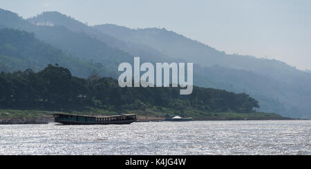 Houseboat travelling along the River Mekong, Laos Stock Photo