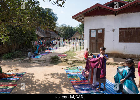 Women selling stoles in village, Sainyabuli Province, Laos Stock Photo