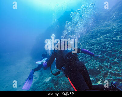 Scuba Divers And Air Bubbles Against The Sunlight Stock Photo