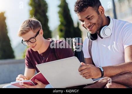 Delighted bearded man using his new laptop Stock Photo