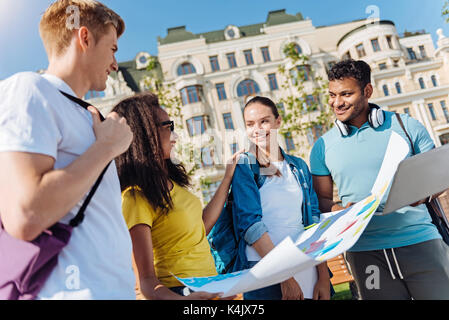 Positive delighted students discussing their work Stock Photo
