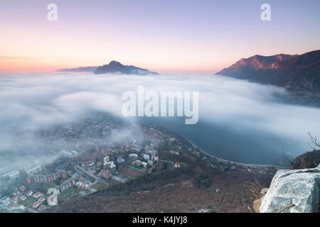 Fog at sunrise above the city of Lecco seen from Monte San Martino, Province of Lecco, Lombardy, Italy, Europe Stock Photo