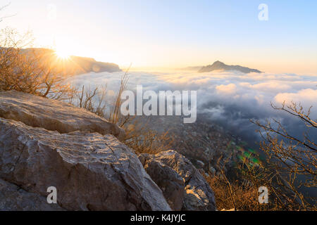Sun and mist above the city of Lecco seen from Monte San Martino, Province of Lecco, Lombardy, Italy, Europe Stock Photo