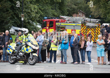 Tour of Britain cycle race passes through Southwell near Newark Nottinghamshire UK on 6th September 2017. shows police motorcycle outrider blocking the road and a nottinghamshire fire and rescue vehicle in background. crowds gathered to watch race. credit steve brownley/alamy live news Stock Photo