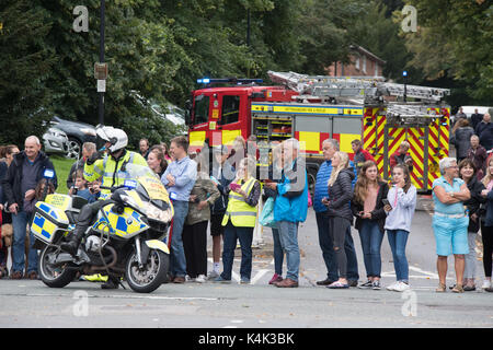 Tour of Britain cycle race passes through Southwell near Newark Nottinghamshire UK on 6th September 2017. photo shows police escort vehicles at junctions and crowds gathered to watch. also shows Nottinghamshire fire and rescue vehicle in background blocking a road credit Steve Brownley/Alamy live news Stock Photo