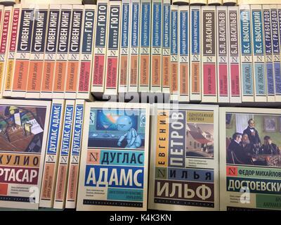 Russian and international classics are standing in a bookshelf of a stand at the international book fair in Moscow, Russia, 06 September 2017. Blue in the middle: Douglas Adams, The Hitchhiker's Guide to the Galaxy; to the right Ilja Ilf/Yevgeni Petrov, One-storied America and Fyodor Dostoyevsky, The Brothers Karamazov.  Circa 600 publishers from 39 countries participate in the largest book fair in Russia and the former Soviet Union, which is on until 10 September 2017. Photo: Friedemann Kohler/dpa Stock Photo